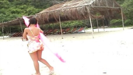 Lovely Asian with a hairy pussy enjoys her body on a nice beach