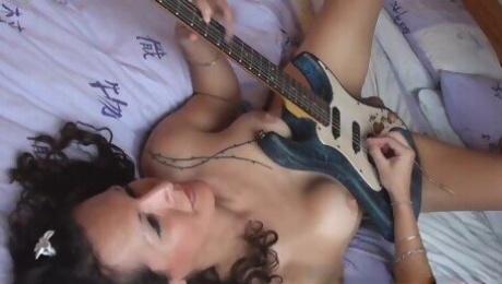 Nikki Montero playing the guitar with her balls, the photoshoot